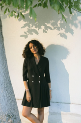 a lady in a black double-breasted lapel dress